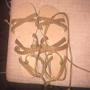 A pair of laced brown sandals